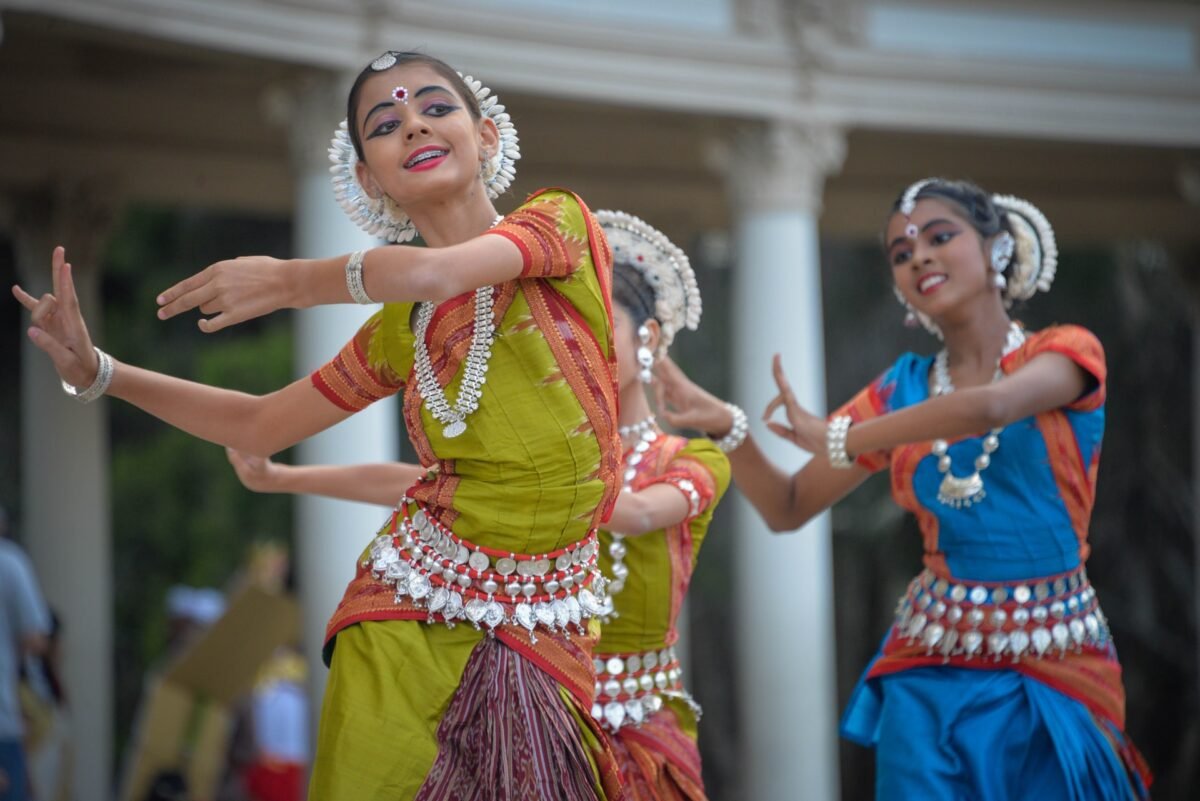 Girls adorned in traditional attire perform a classical hindu dance